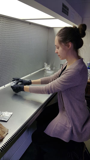 Molly Tillmann in lab working with gloves on